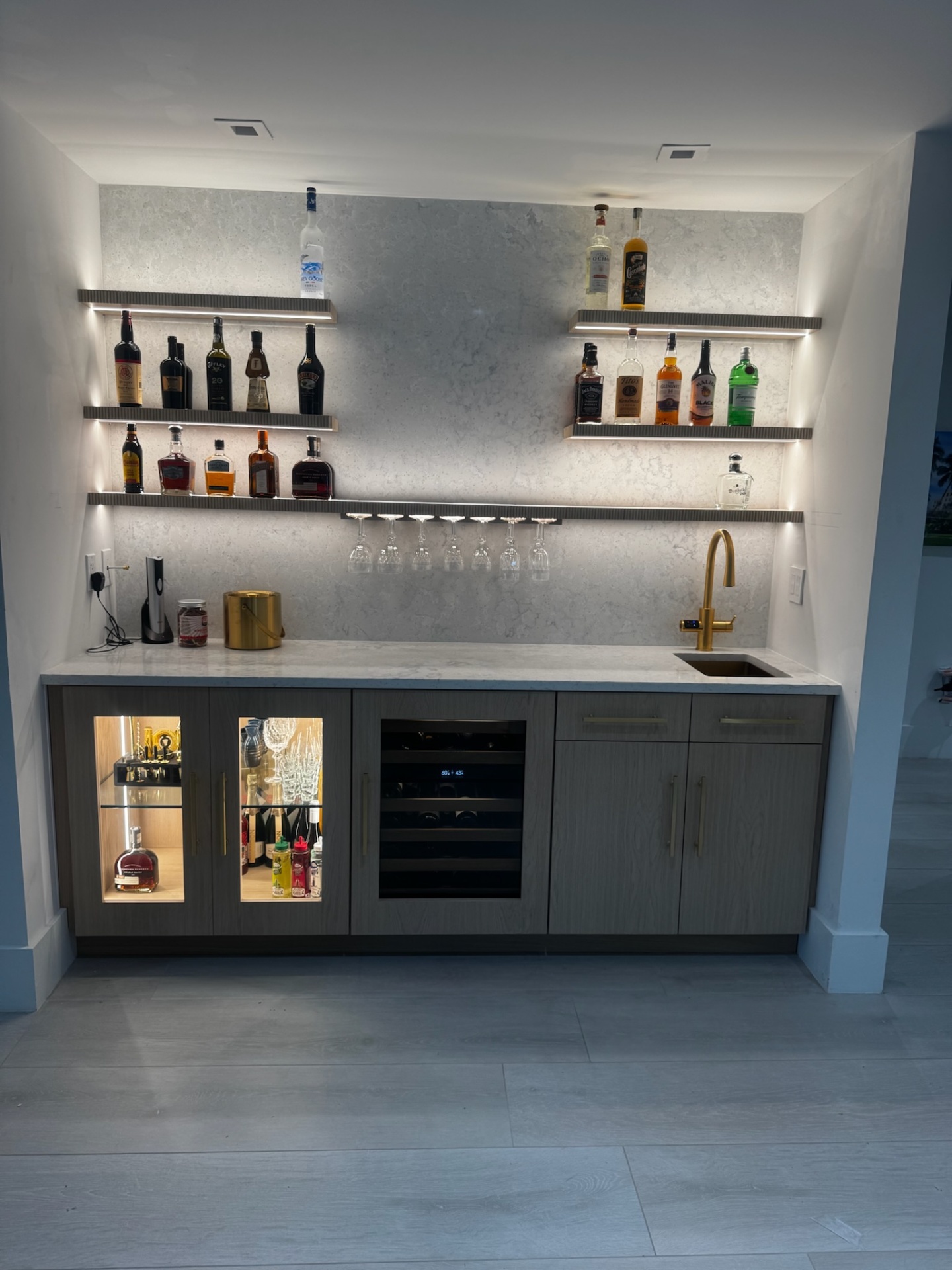 Custom wet bar cabinetry with floating shelves