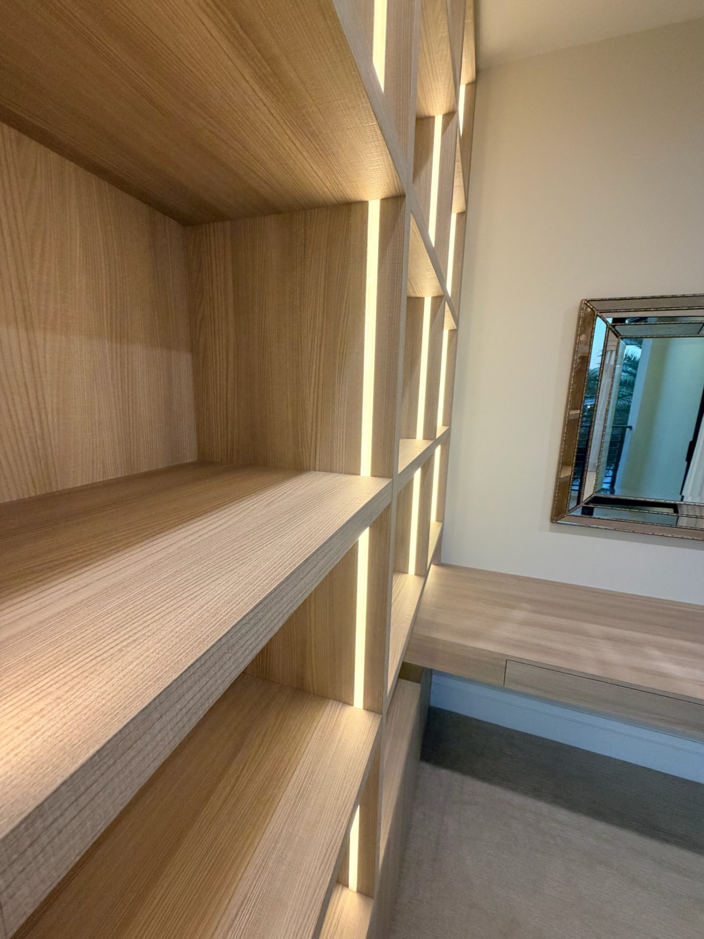 Custom oak built-in shelving detail with integrated LED lighting